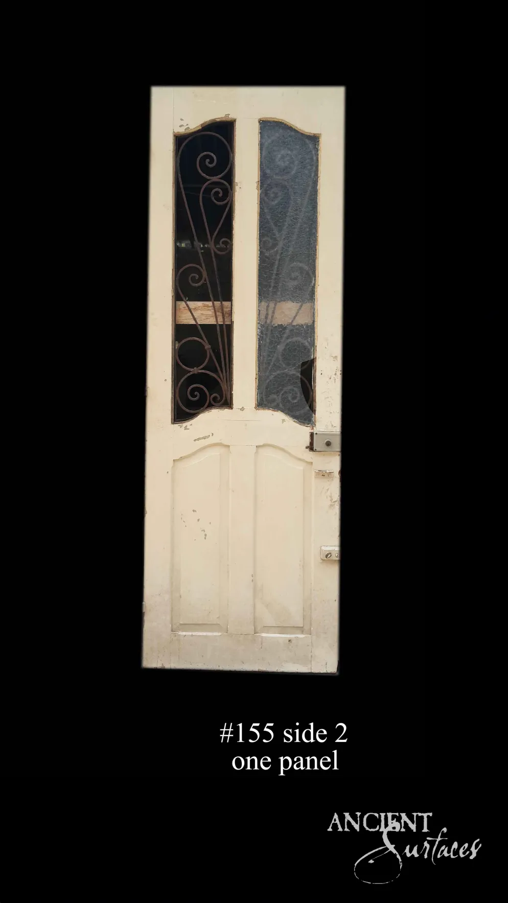 Cream single reclaimed antique door with arched glazed panels and wrought-iron scroll grilles